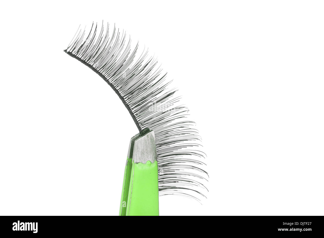 False lashes and green pincers, closeup on white background  Stock Photo