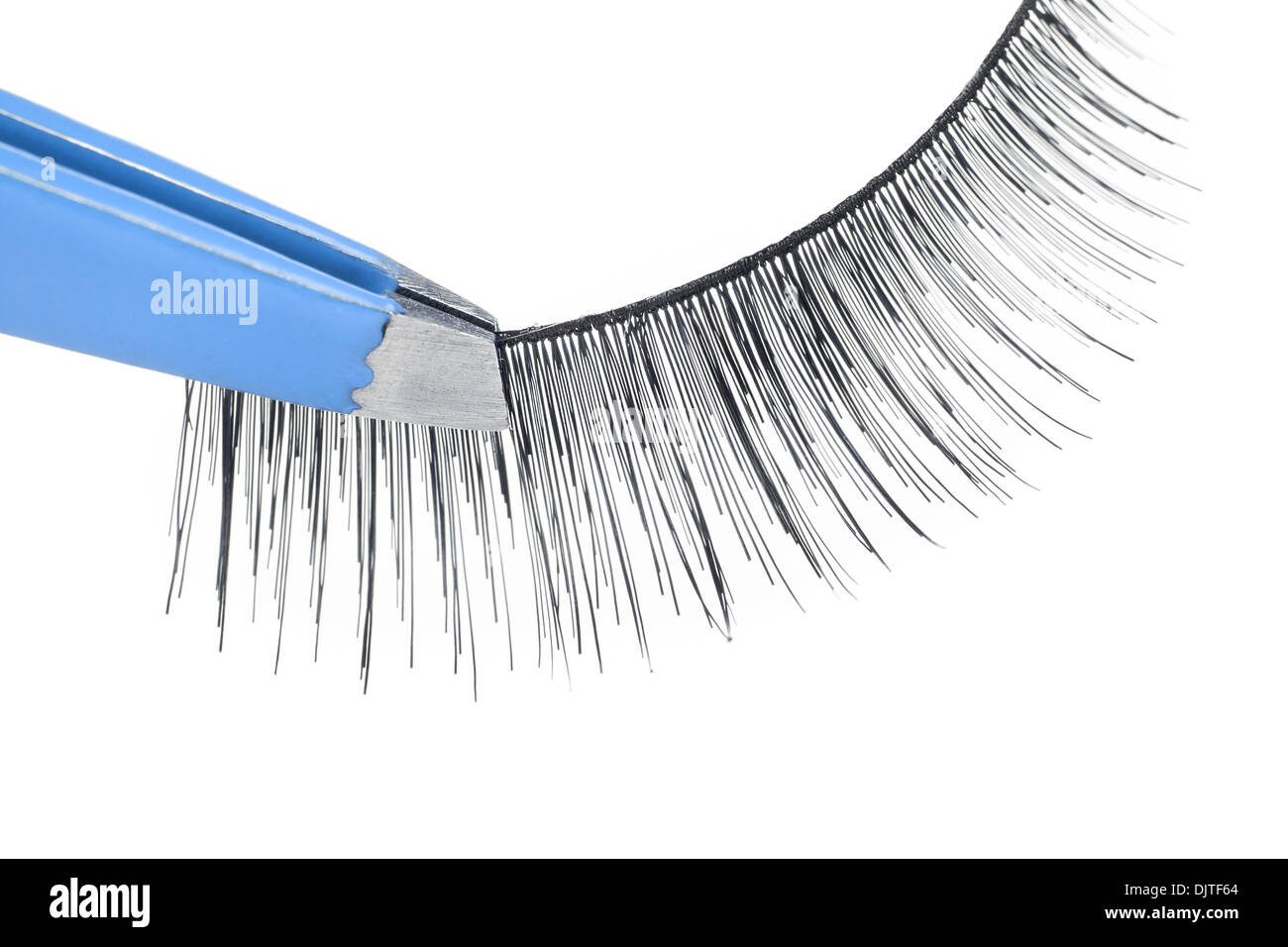 False lashes and blue pincers, closeup on white background  Stock Photo