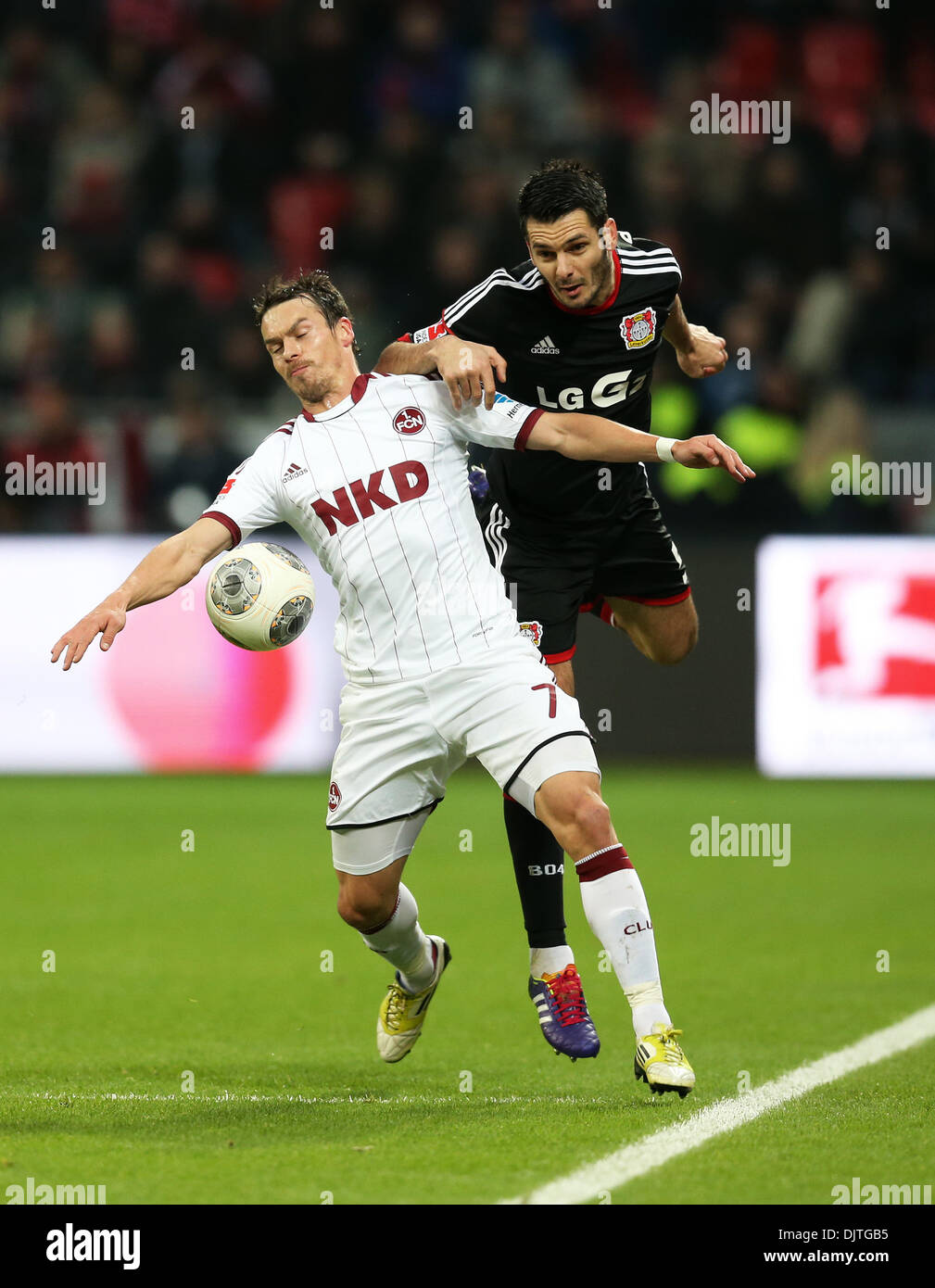 Leverkusen, Germany. 30th Nov, 2013. Nuremberg's Markus Feulner (L) and Leverkusen's Emir Saphic vie for the ball during the Bundesliga soccer match between Bayer o4 Leverkusen and 1. FC Nuremberg in the BayArena in Leverkusen, Germany, 30 November 2013. Photo: Rolf Vennenbernd/dpa (ATTENTION: Due to the accreditation guidelines, the DFL only permits the publication and utilisation of up to 15 pictures per match on the internet and in online media during the match.)/dpa/Alamy Live News Stock Photo