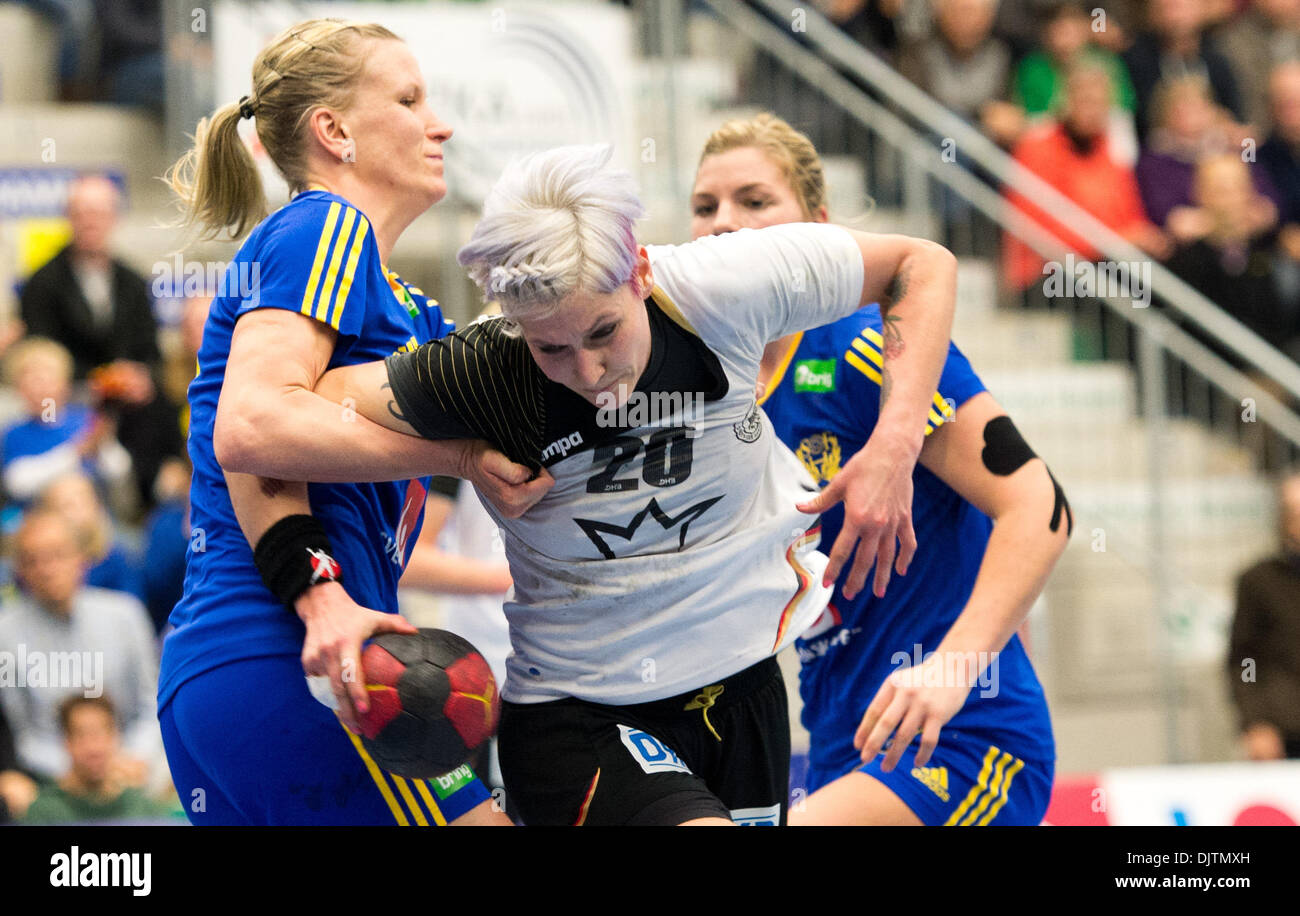 Hamm, Germany. 30th Nov, 2013. Germany's Anja Althaus (M) and Sweden's Anna-Maria Johansson (L) vie for the ball during the women handball international between Germany and Sweden at MaxiPark Arena in Hamm, Germany, 30 November 2013. Photo: BERND THISSEN/dpa/Alamy Live News Stock Photo