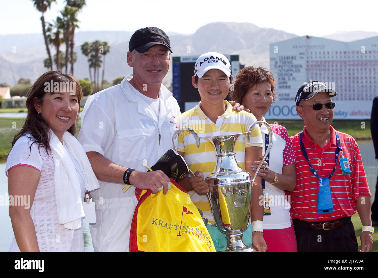 Yani Tseng (white shirt with yellow stripes) pictured with her caddy