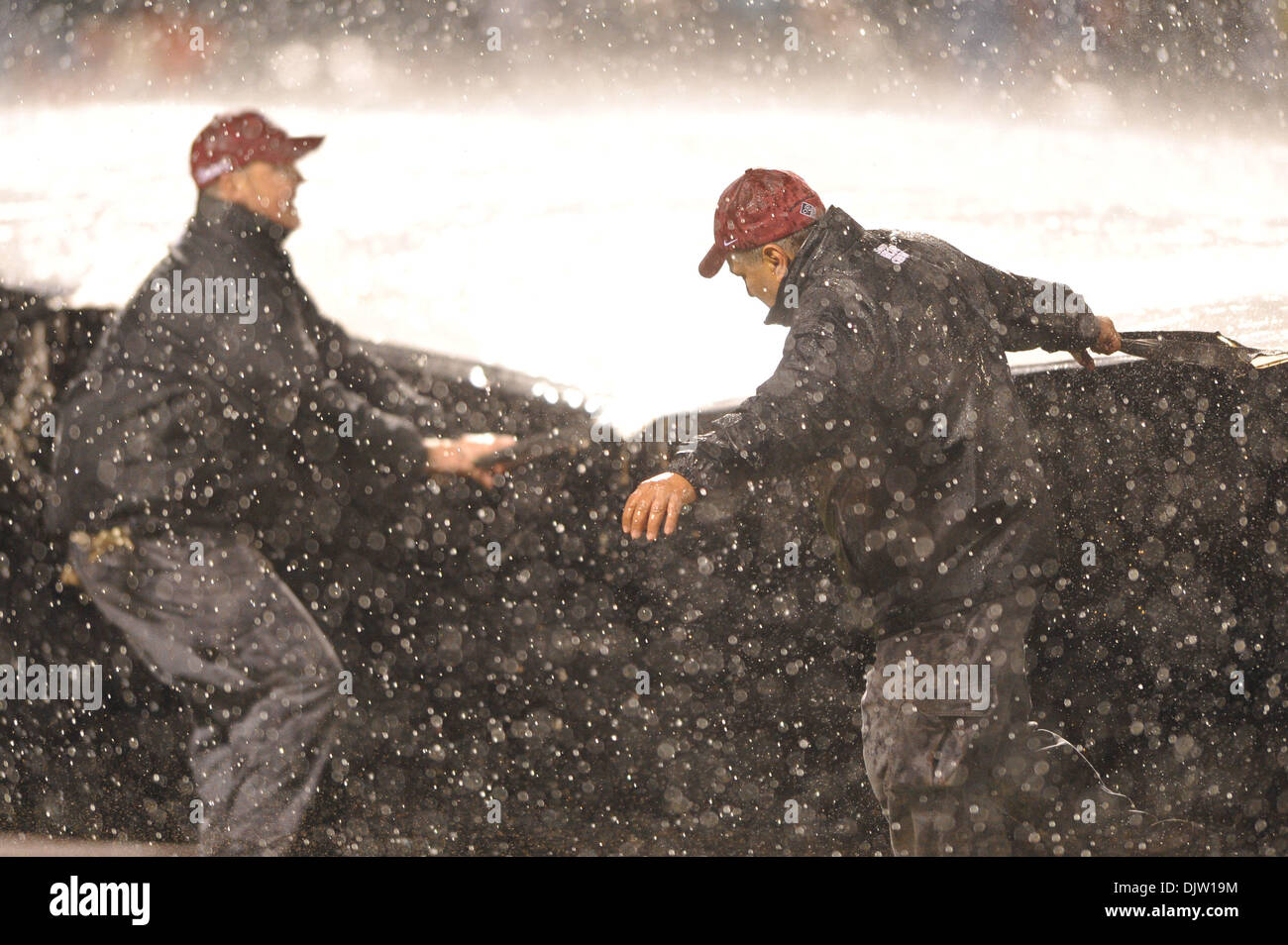 20 April, 2010: The Mets ground crew roll out the tarp during a rain ...