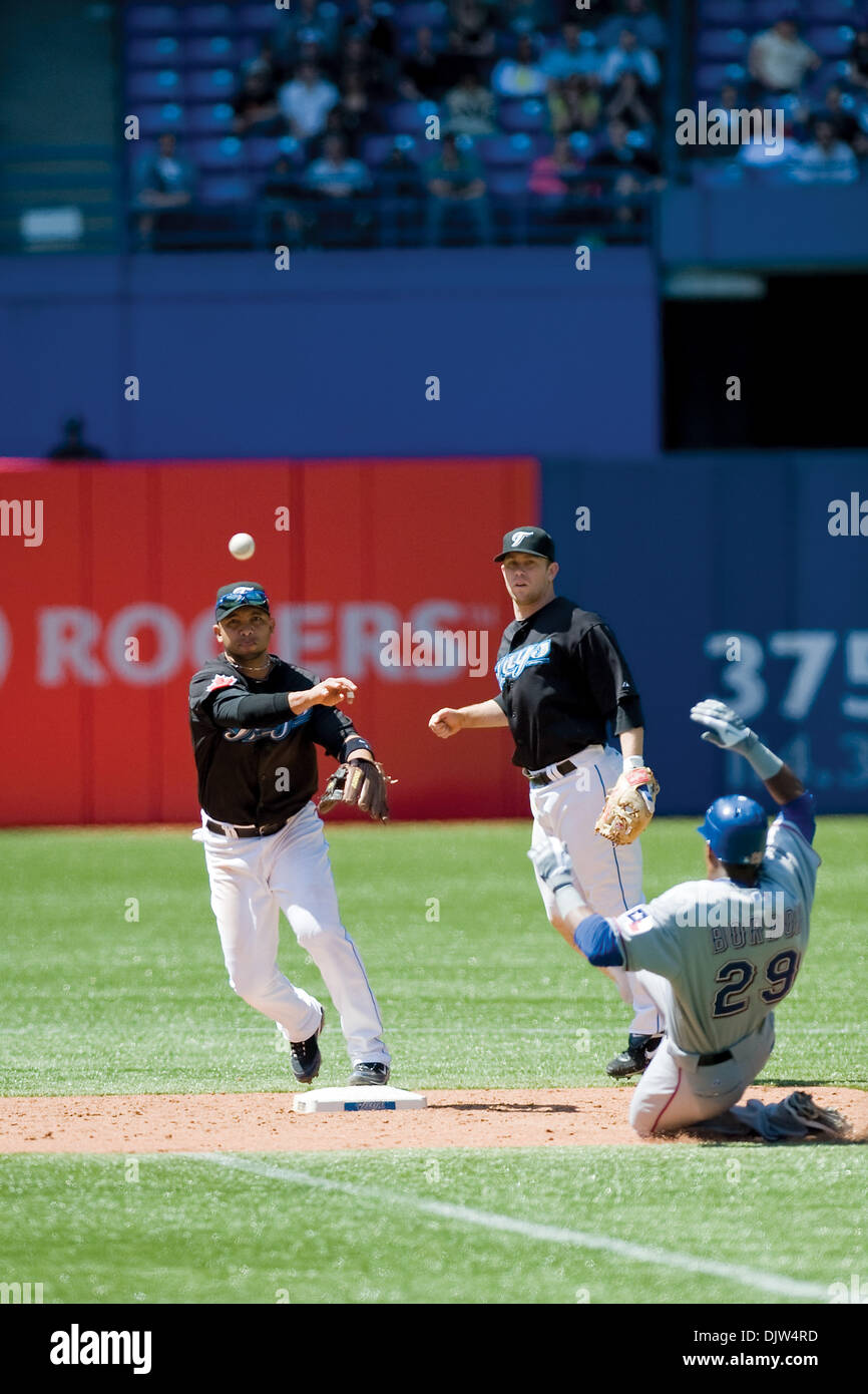 Toronto Blue Jays Alex Gonzalez 11 throws to first base as part of a