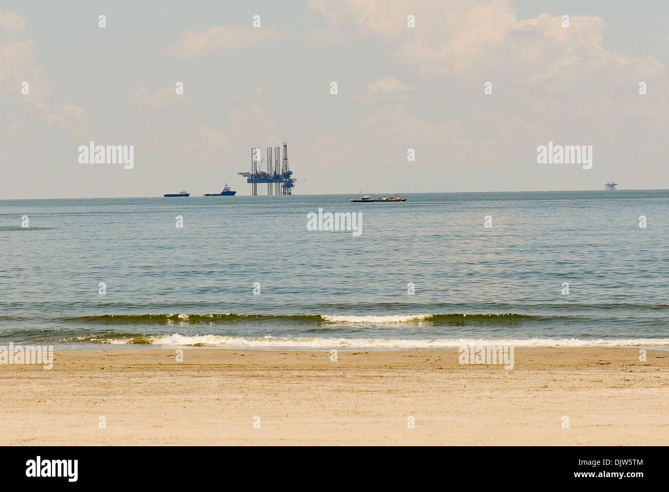Working rigs are visible from Grand Isle beach in Grand Isle, Louisiana