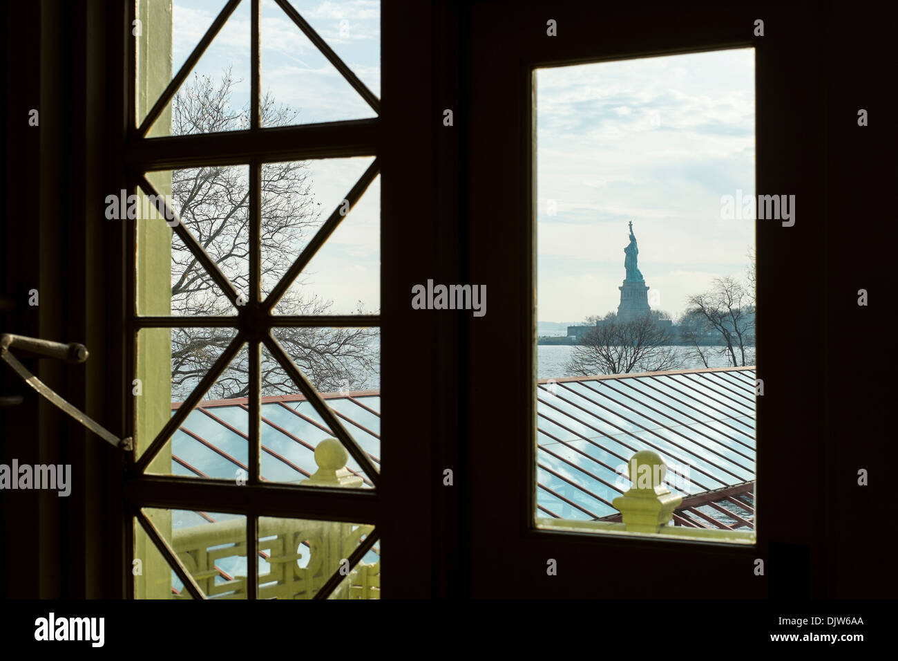 Statue of Liberty framed by Ellis Island hall window, in New York, US Stock Photo