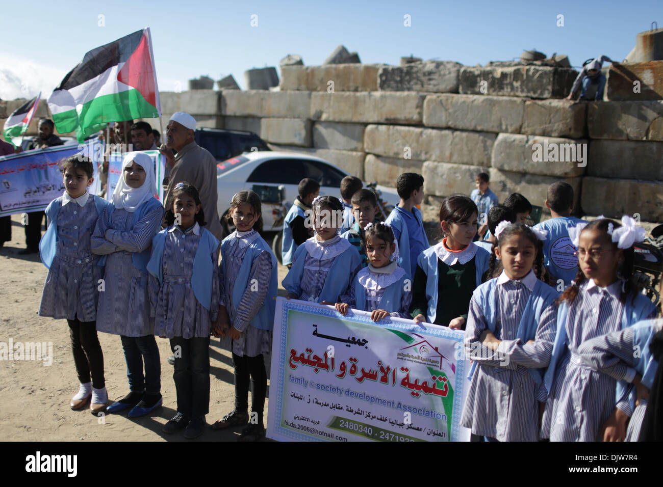 (131130) -- GAZA, Nov. 30, 2013 (Xinhua)  -- Palestinian children hold banners and Palestinian national flags during a protest against Israel's maritime blockade on the Gaza Strip at a port in Gaza City, Nov. 30, 2013. (Xinhua/Wissam Nassar) Stock Photo