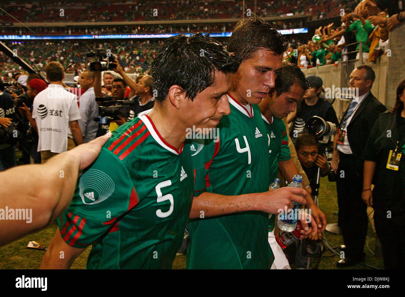 Ricardo Osorio (#5) Defender for Mexico, Hector Moreno (#4) Defender for Mexico, and Francesco Rodriguez (#2) Defender for Mexico exit the field following the match against Angola.  Mexico defeated Angola 1-0 at Reliant Stadium in Houston, TX. (Credit Image: © Anthony Vasser/Southcreek Global/ZUMApress.com) Stock Photo
