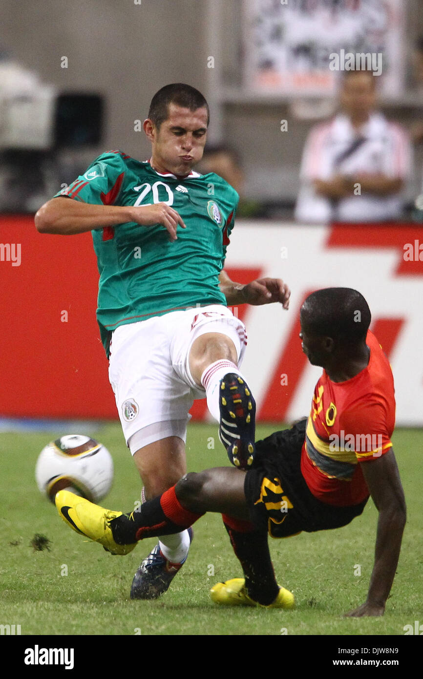 Mambina (#21) Midfielder for Angola tackles the ball away from Jorge Torres Nilo (#20) Defender for Mexico.  Mexico defeated Angola 1-0 at Reliant Stadium in Houston, TX. (Credit Image: © Anthony Vasser/Southcreek Global/ZUMApress.com) Stock Photo