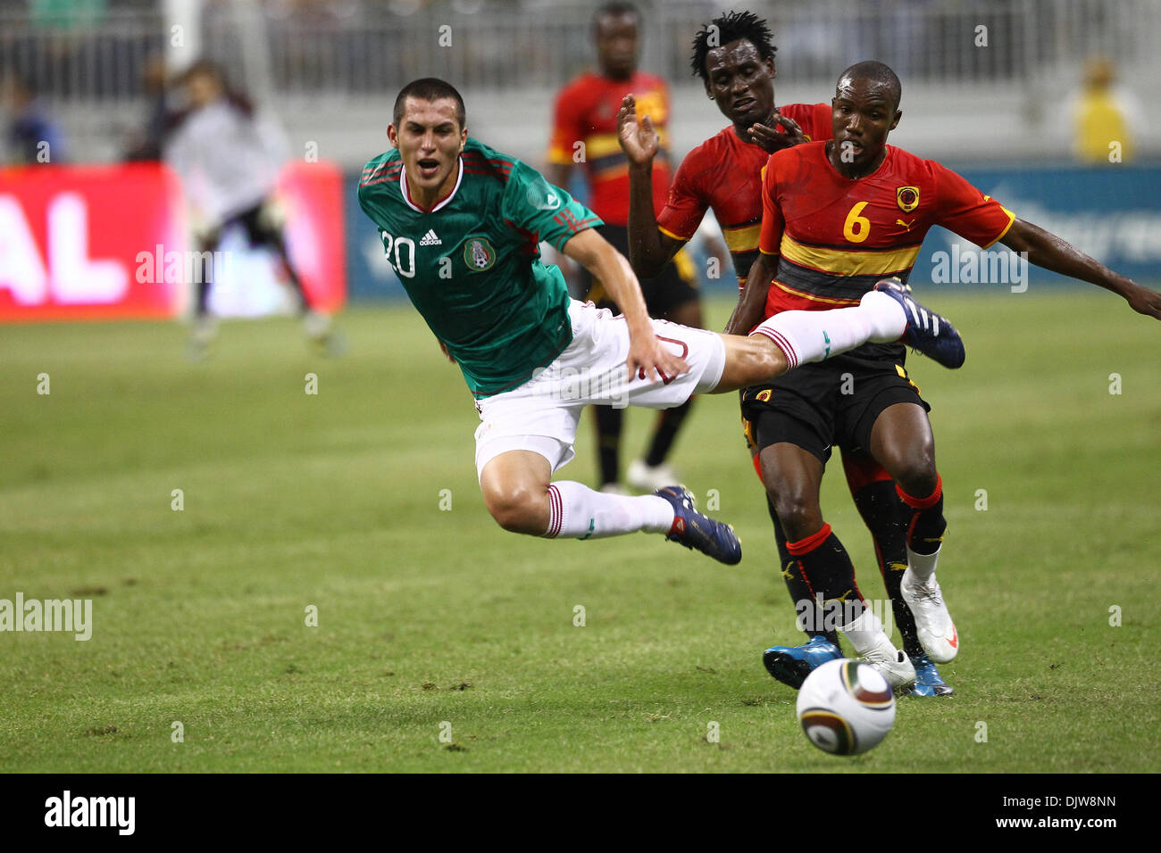 Jorge Torres Nilo (#20) Defender for Mexico gains air after being tackled from behind by Pataca (#6) Midfielder for Angola.  Mexico defeated Angola 1-0 at Reliant Stadium in Houston, TX. (Credit Image: © Anthony Vasser/Southcreek Global/ZUMApress.com) Stock Photo