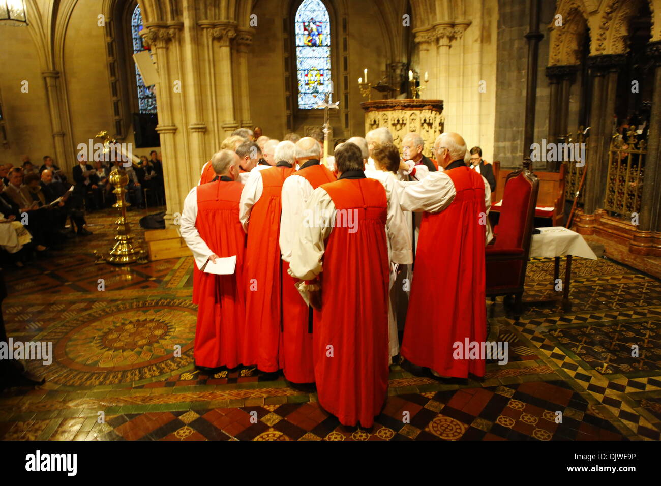 Dublin, Ireland. 30th November 2013. The attending bishops surround the bishop-elect the Revd Pat Storey and the consecrating Bishops, laying their hands on her to consecrate her. The Most Revd Pat Storey has been consecrated as Church of Ireland Bishop of Meath and Kildare in Dublin's Christ Church Cathedral. Credit:  Michael Debets/Alamy Live News Stock Photo