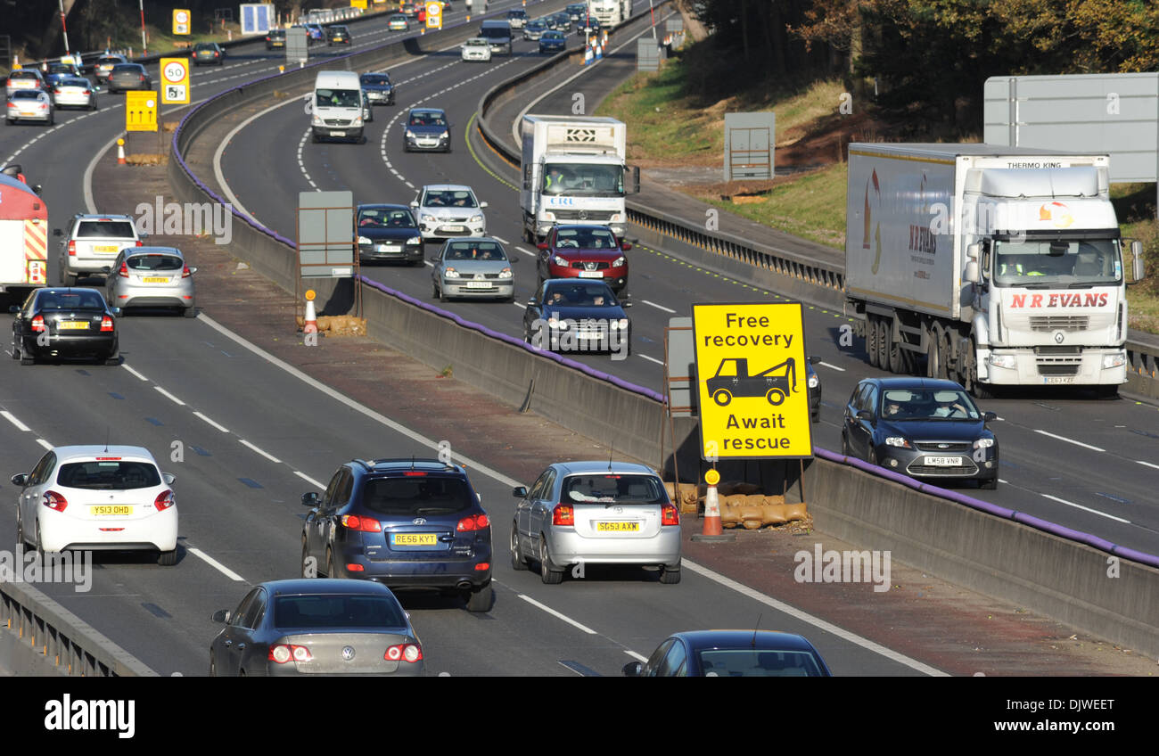 TRAFFIC TRAVELLING IN ROADWORKS SECTION OF THE M6 MOTORWAY WITH FREE BREAKDOWN RECOVERY SIGN SPEED LIMIT 50MPH CAMERAS GATSO UK Stock Photo