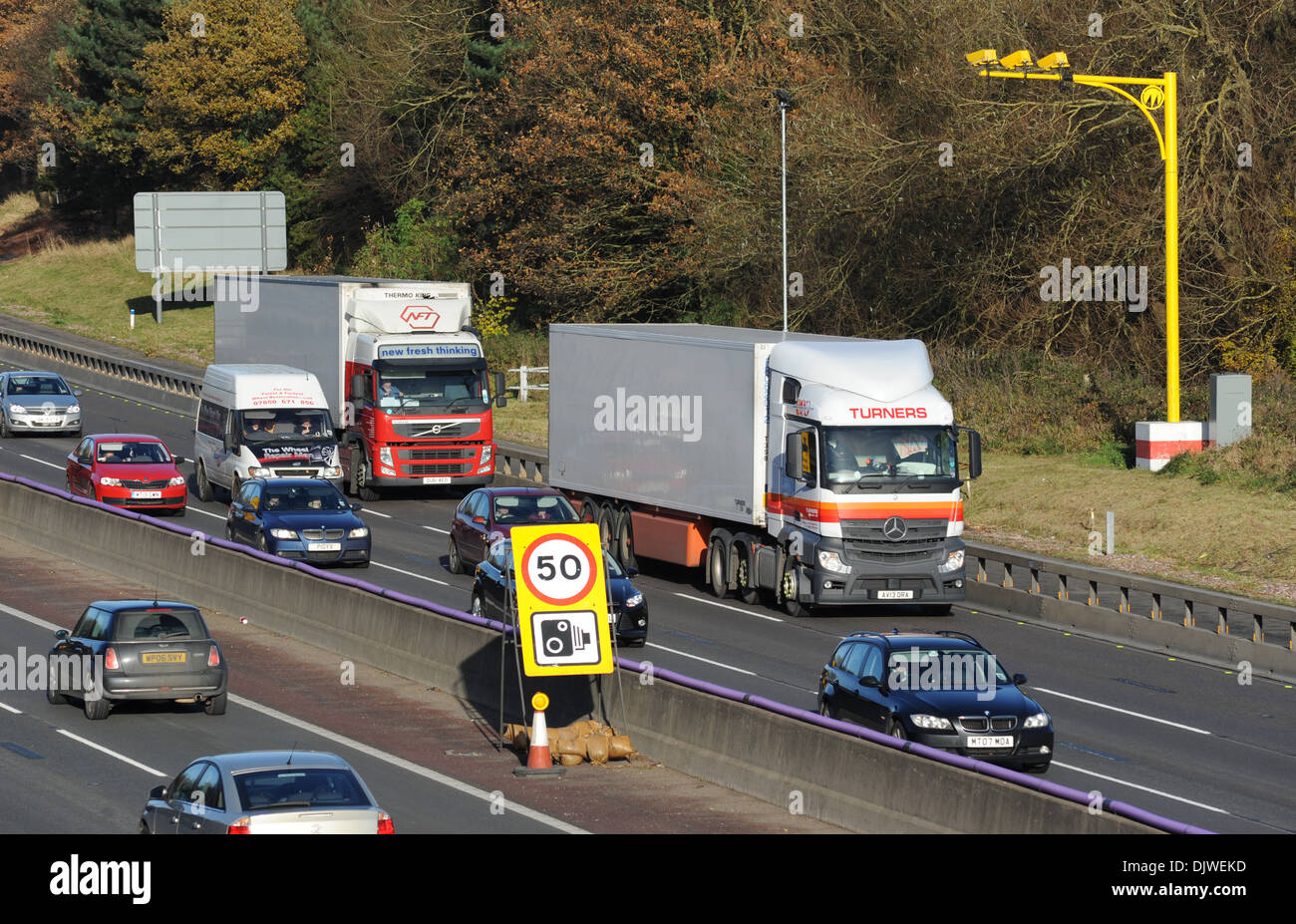TRAFFIC TRAVELLING IN ROADWORKS SECTION OF THE M6 MOTORWAY WITH SPEED LIMIT 50MPH SIGN CAMERAS SAFETY MOBILE GATSO UK Stock Photo