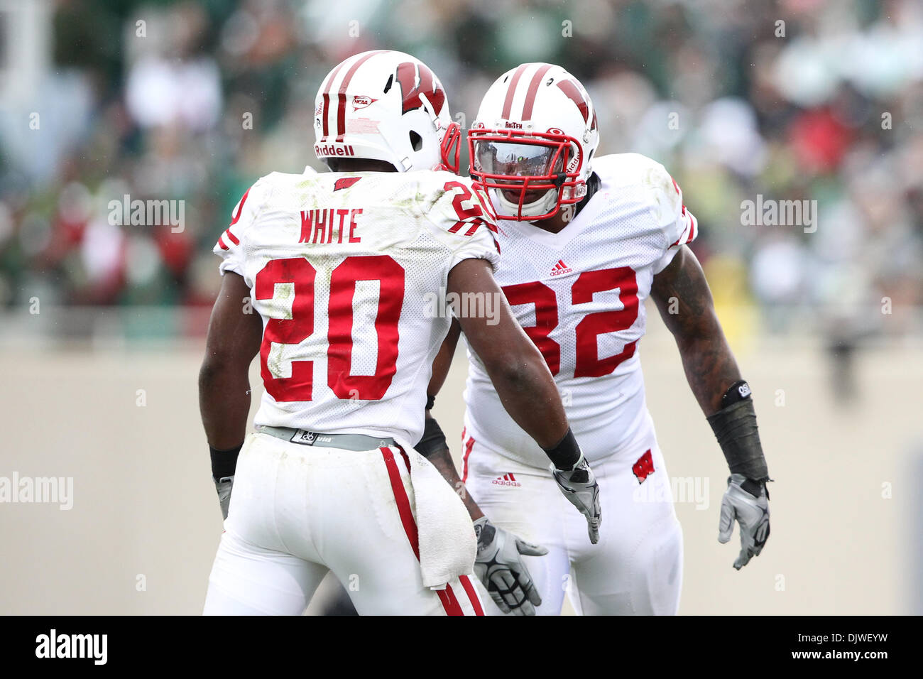 Oct. 2, 2010 - East Lansing, Michigan, United States of America - Wisconsin Badgers running back James White (20) celebrates with Wisconsin Badgers running back John Clay (32) after scoring a  touchdown during the game against the Michigan State Spartans at Spartan Stadium. (Credit Image: © Rey Del Rio/Southcreek Global/ZUMApress.com) Stock Photo