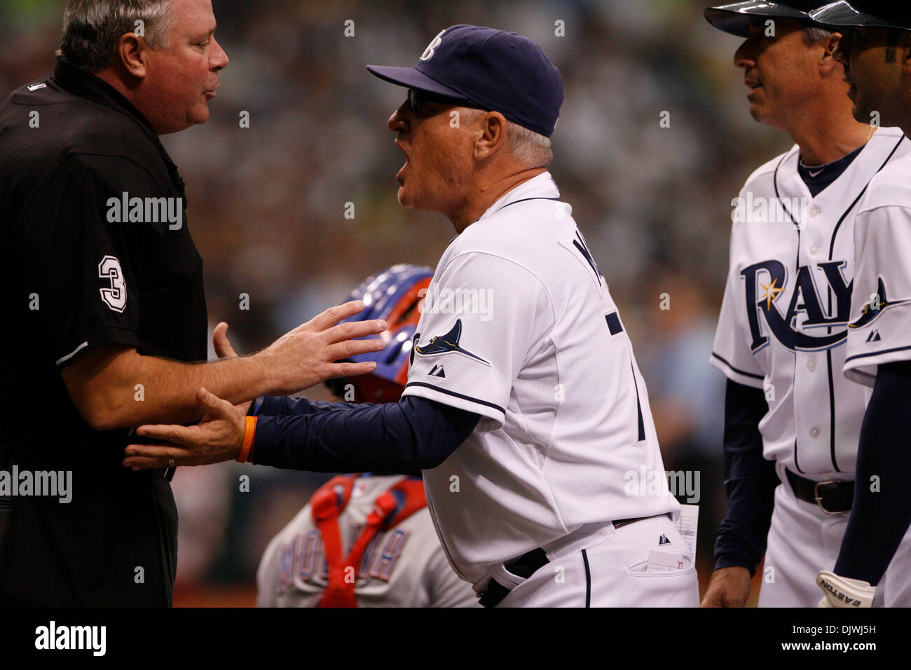 Oct. 6, 2010 - St. Petersburg, FL - BRUCE MOYER / TIMES.SP 329177 MOYE Rays 01.CAPTION: (10/06/10)(St. Petersburg, FL) Tampa Bay manager Joe Maddon (center) argues with home plate umpire Tim Welke (left) in the first inning. Maddon felt that Carlos Pena was hit by a pitch during the Tampa Bay Rays ALDS playoff game against The Texas Rangers at Tropicana Field on Wednesday, Oct. 10, Stock Photo