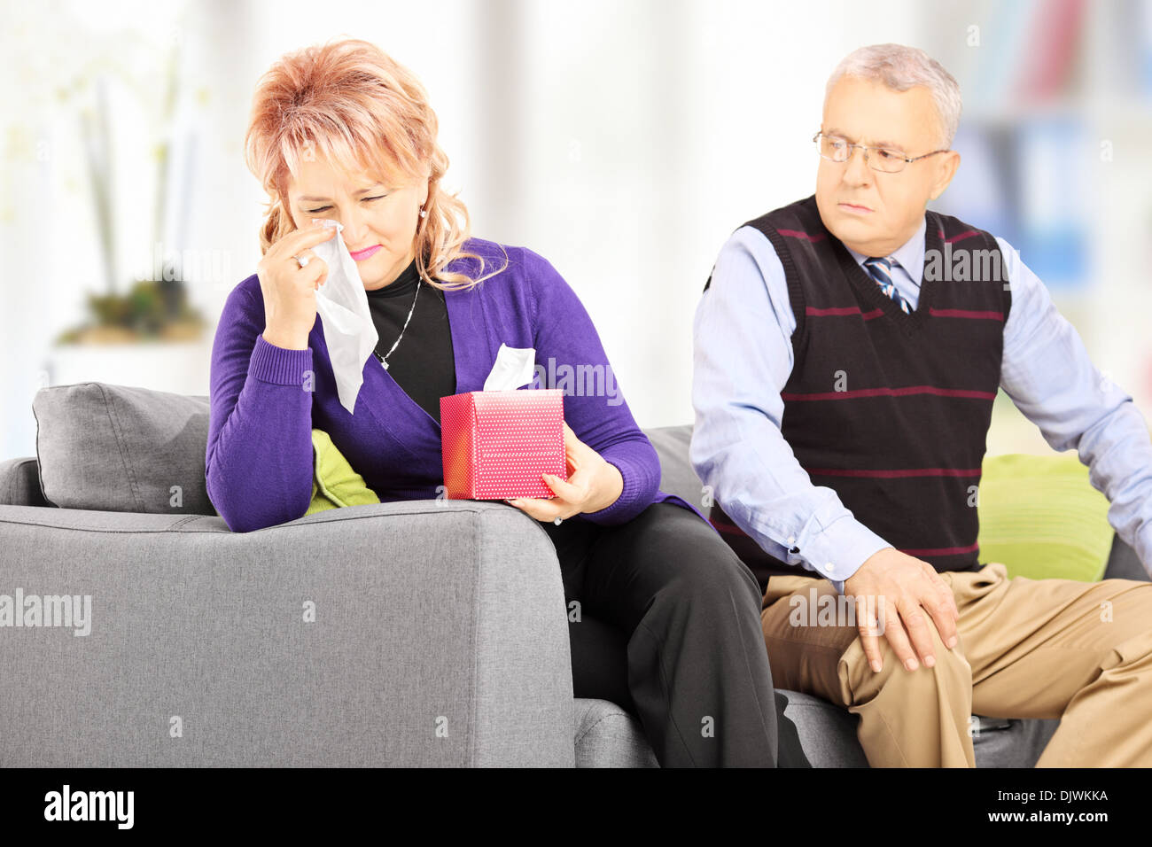 Woman wiping his eyes from crying after quarrel with her husband Stock Photo