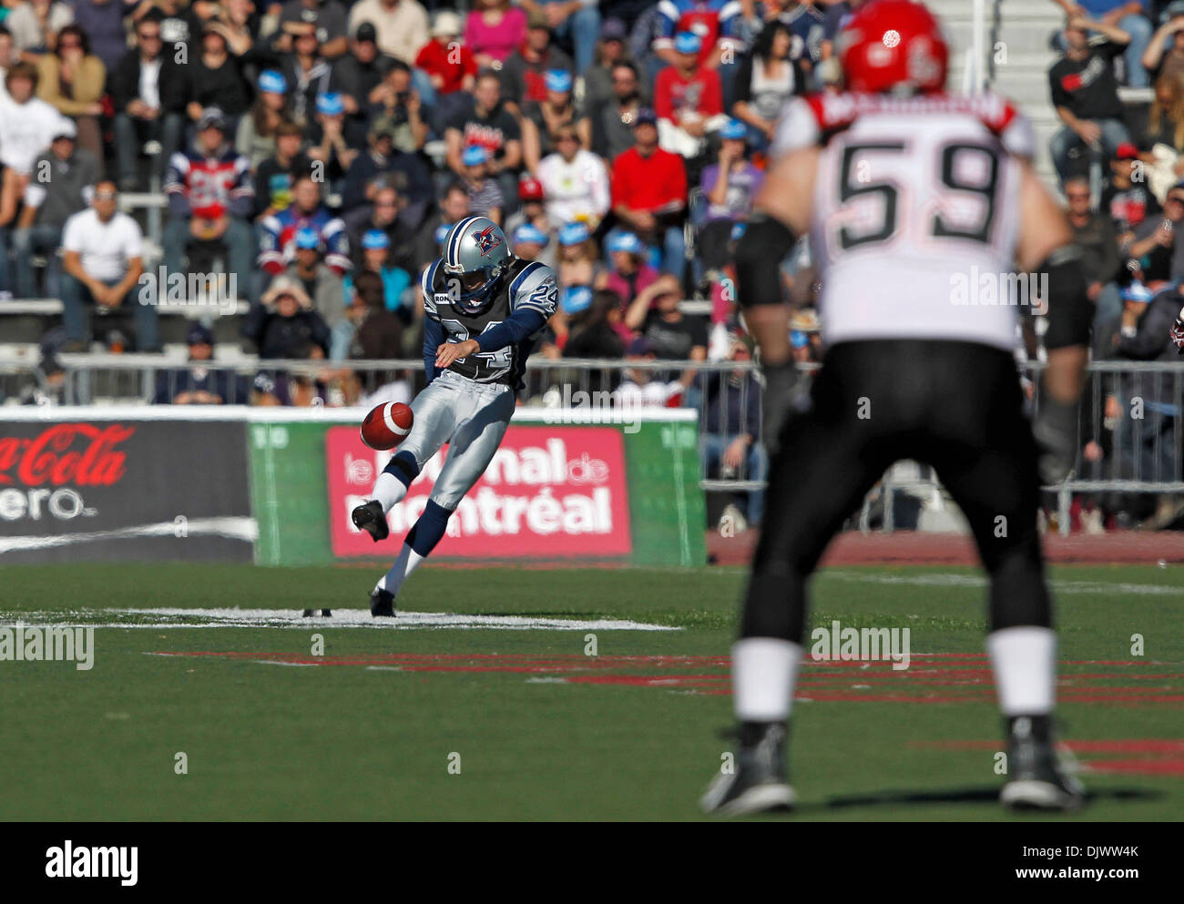 Oct. 11, 2010 - Montreal, Quebec, Canada - Montreal Alouettes' punter/kicker Colt David (#24) punts under the watchfull eye of Calgary Stampeders' offensive lineman Steve Myddelton (#59) during the CFL game between the Calgary Stampeders and the Montreal Alouettes at Percival-Molson Stadium. Montreal won 46-19. (Credit Image: © Phillippe Champoux/Southcreek Global/ZUMApress.com) Stock Photo