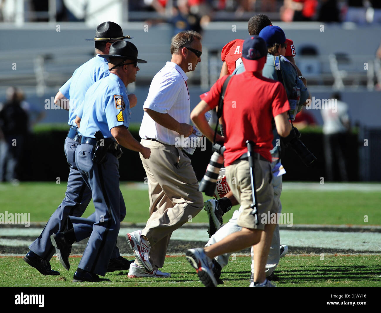 Oct. 16, 2010 - Athens, Georgia, United States of America - Georgia head coach Mark Richt is escorted to midfield for the post game hand shake between head coaches after SEC Football action between Vanderbilt and Georgia. Georgia defeated Vanderbilt 43-0 in the game at Sanford Stadium in Athens, GA. (Credit Image: © David Douglas/Southcreek Global/ZUMApress.com) Stock Photo