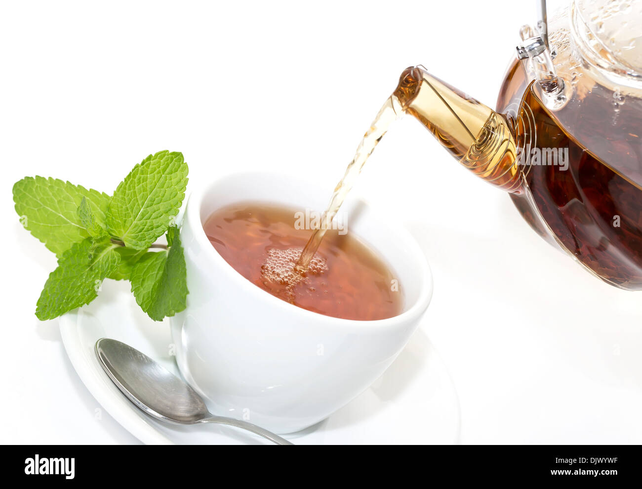 tea poured from a teapot on a white background in the restaurant Stock Photo