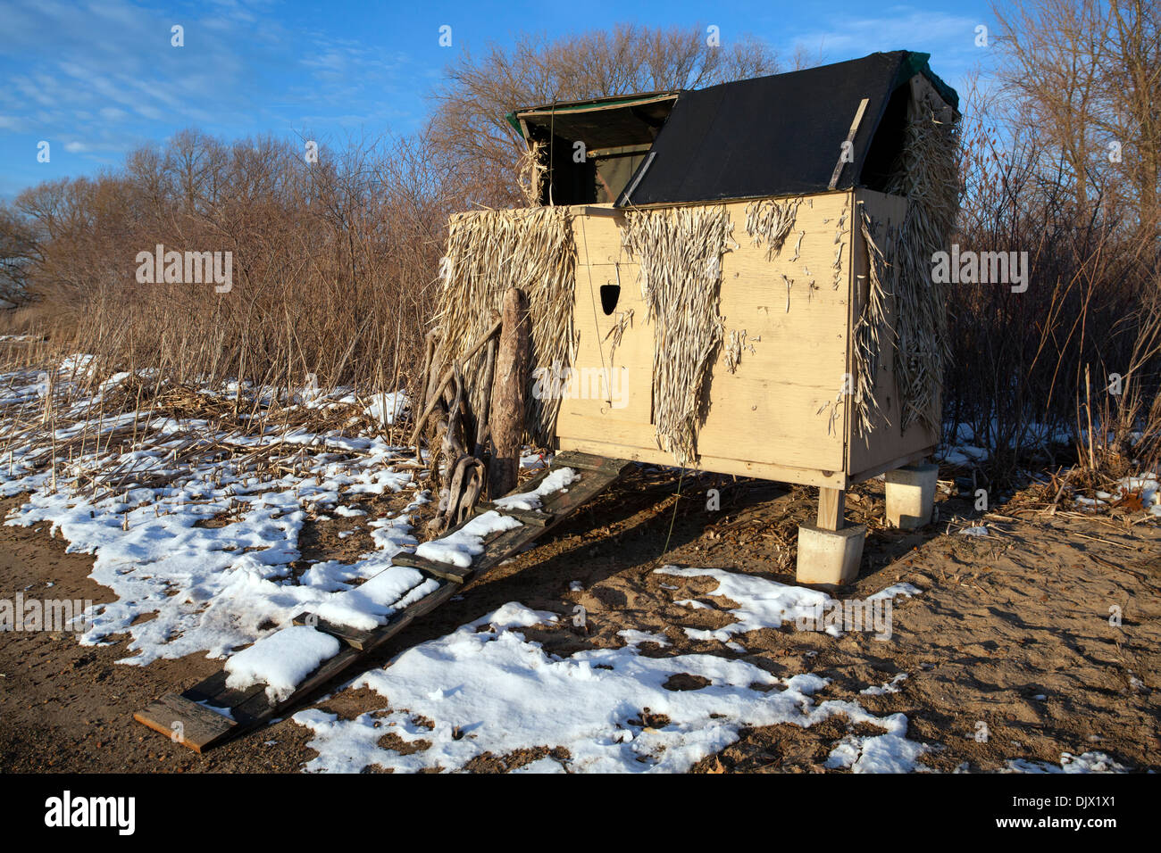A duck blind along the shore of Presque Isle Bay in Erie, Pennsylvania in the winter with snow on the ground. These are privately owned structures. Stock Photo
