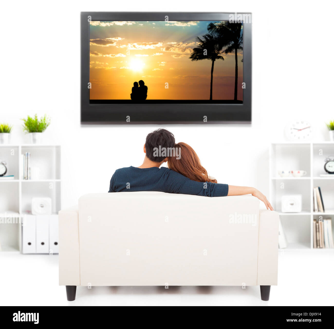 young couple on sofa watching TV Stock Photo Alamy