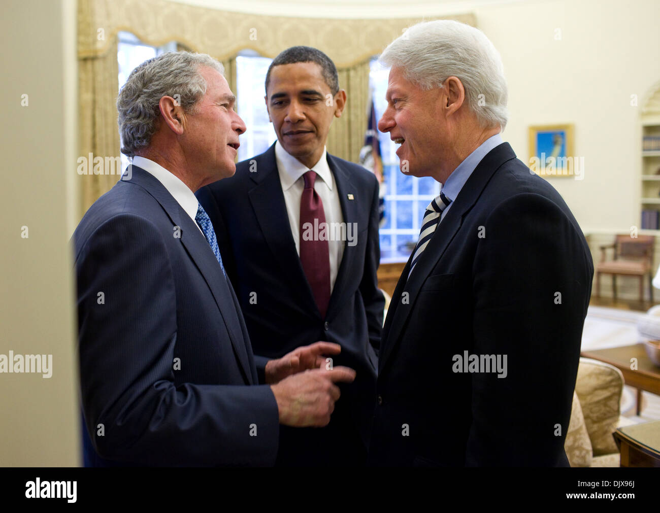 US President Barack Obama looks on as former President George W. Bush jokes with former President Bill Clinton in the Oval Office of the White House January 16, 2010 in Washington, DC. President Obama asked the two former Presidents to help with the earthquake in Haiti. Stock Photo