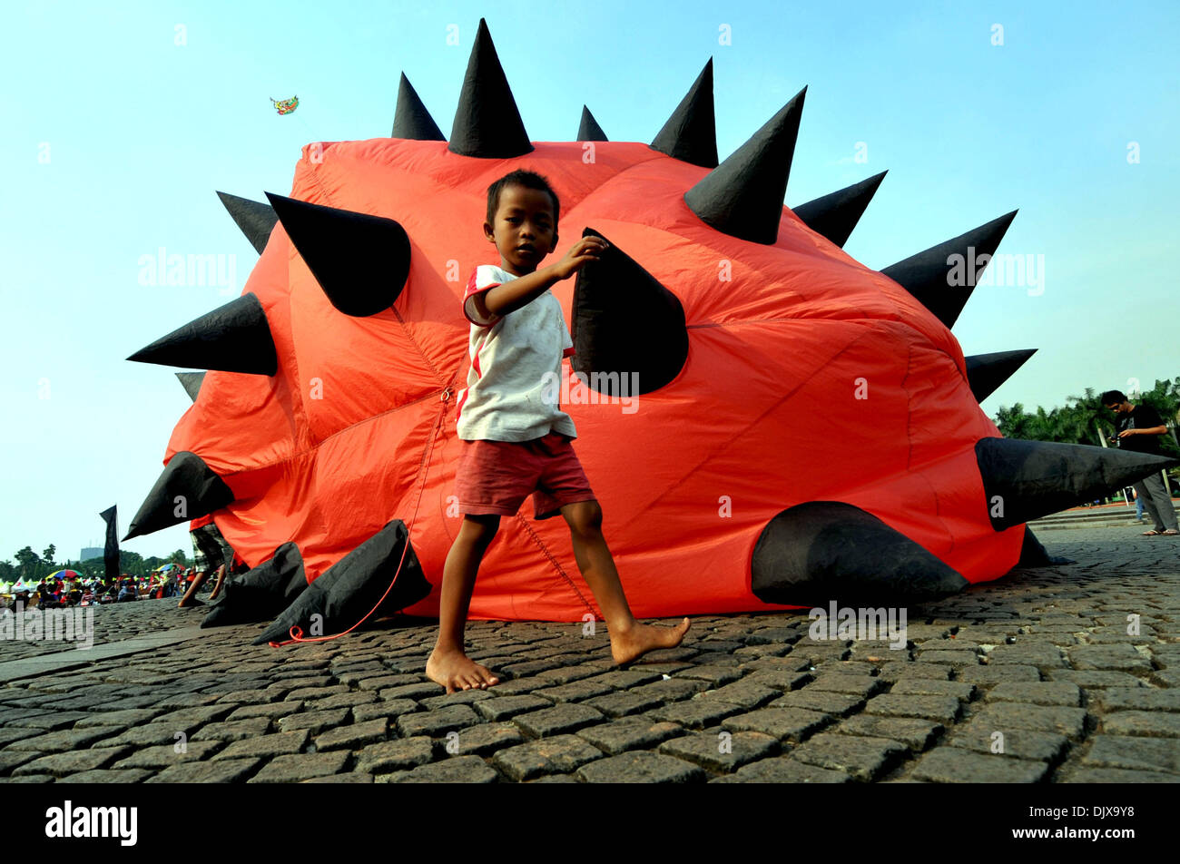 Jakarta, Indonesia. 1st Dec, 2013. A boy walks past a kite during the Jakarta International Kite Festival 2013 in Jakarta, Indonesia, Nov. 30, 2013. The two-day festival opened on Saturday, with the participation of 18 countries and regions. Credit: Agung Kuncahya B./Xinhua/Alamy Live News Stock Photo