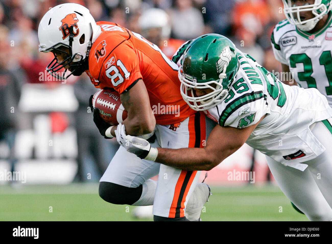 Oct. 31, 2010 - Vancouver, British Columbia, Canada - Lions #81 SB Geroy Simon getting tackled by Roughriders #95 DE Luc Mullinder during the sunday game at Empire field BC Lions won the game with a score of 23 to 17 against the Saskatchewan Roughriders for their last home game of the season (Credit Image: © James Healey/Southcreek Global/ZUMApress.com) Stock Photo