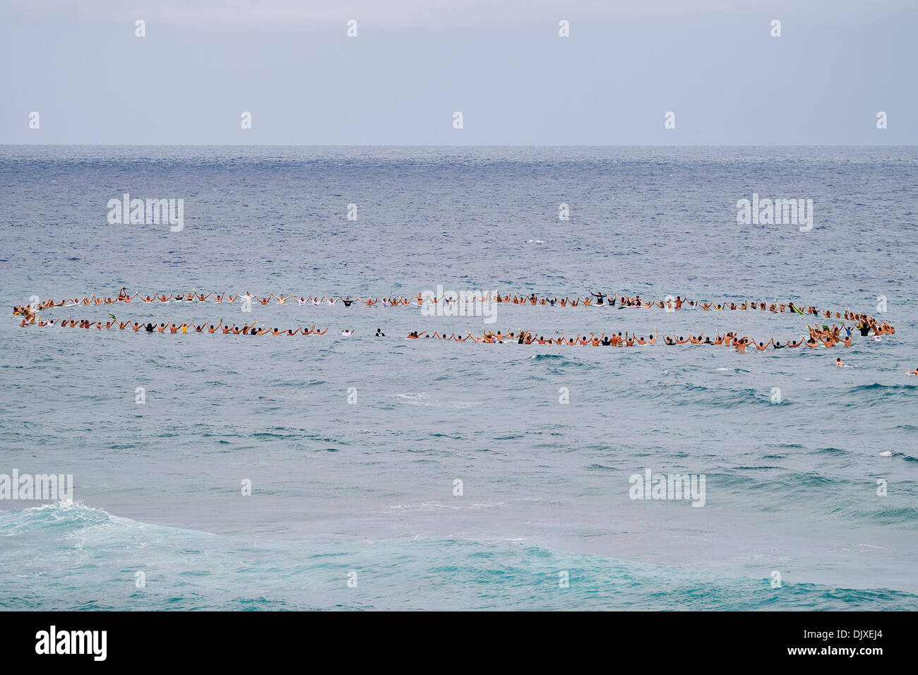 Nov 03, 2010 - Porta Del Sol, Puerto Rico, U.S. - Surfers raise their arms in honour of the late Andy Irons (Haw) during a paddle out memorial service held at Middles Beach in Porta Del Sol, Puerto Rico today. Irons's friends Roy Powers (HAW) and Dusty Payne (HAW)  lead the paddle out followed by fellow ASP World Tour surfers, friends, industry representatives and fans who carried  Stock Photo