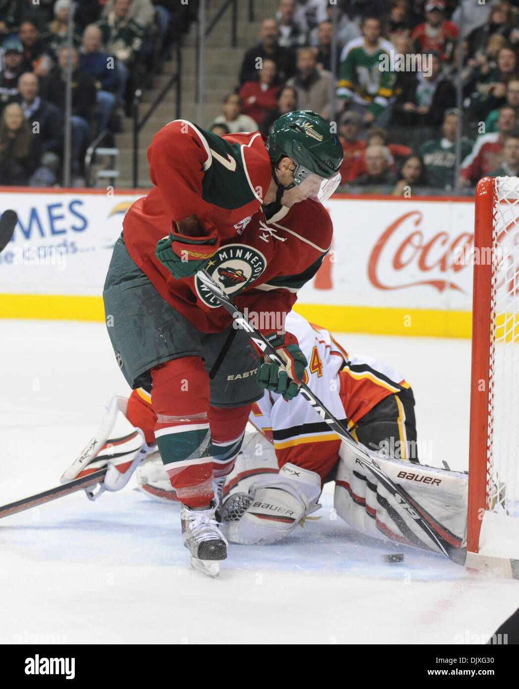 Nov. 5, 2010 - Minneapolis, Minnesota, United States of America - Minnesota Wild center Matt Cullen (#7) continues to work the puck at the toe of the goalie as center Kyle Brodziak (#21) looks for a rebound in the first period of the game between the Calgary Flames and the Minnesota Wild at Xcel Energy Center in St. Paul, Minnesota.  The Wild are tied 1-1 with the Flames after one  Stock Photo