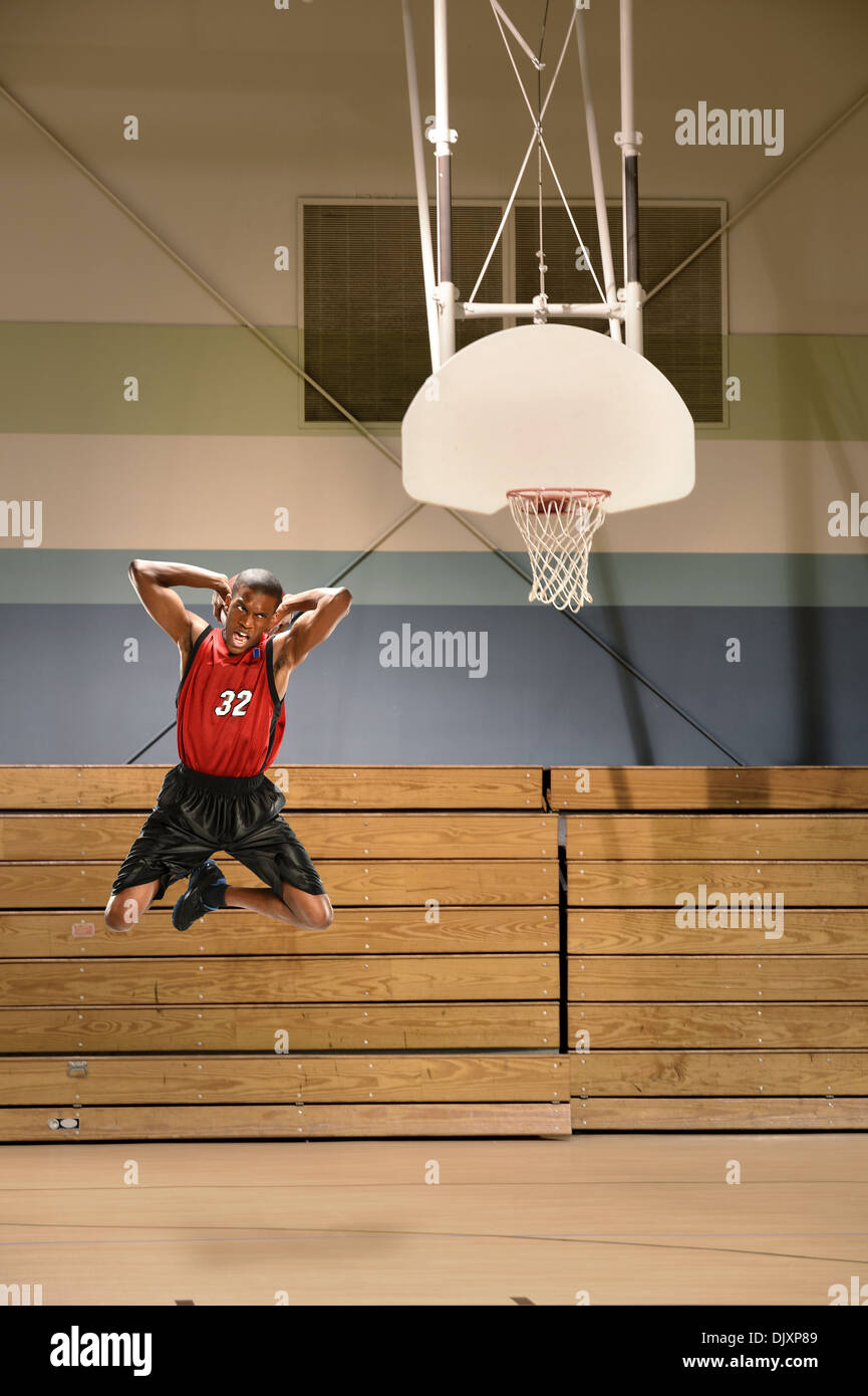 African American basketball player dunking ball Stock Photo
