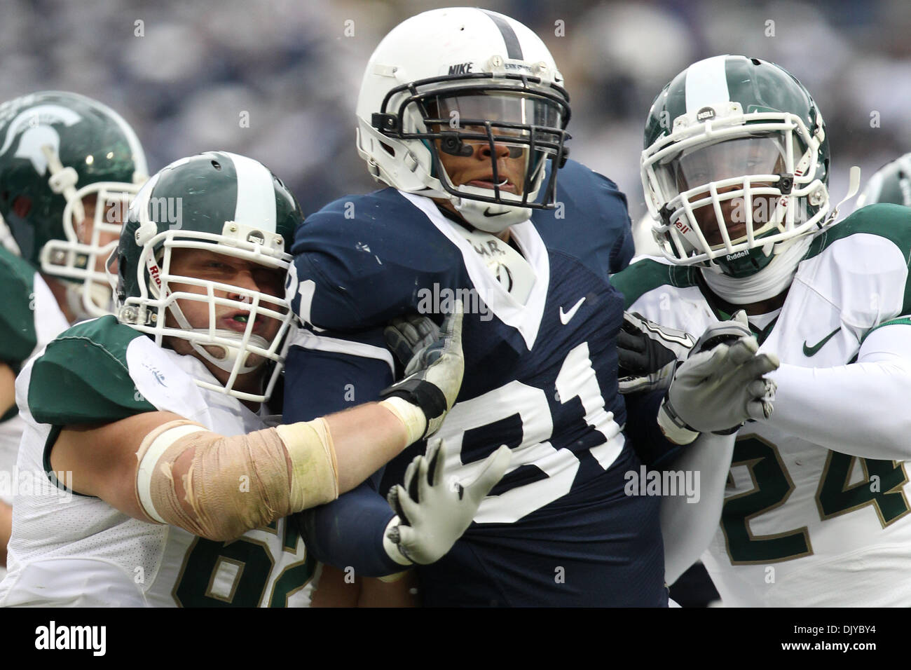 Nov. 27, 2010 - University Park, Pennsylvania, United States of America - Penn State Nittany Lions defensive end Jack Crawford (81) is double teamed by Michigan State Spartans guard Chris McDonald (62) and  running back Le'Veon Bell (24) during game action at Beaver Stadium in University Park, Pennsylvania. (Credit Image: © Alex Cena/Southcreek Global/ZUMAPRESS.com) Stock Photo