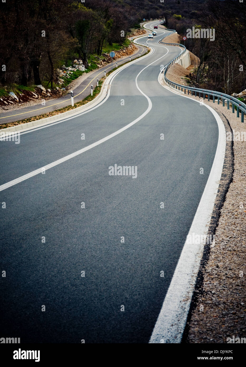 Curved road with cars in the background Stock Photo