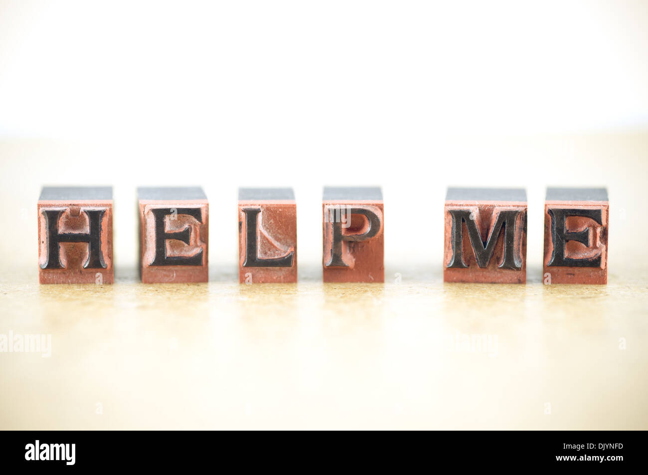 "help me" spelled out in letterpress letters. Stock Photo