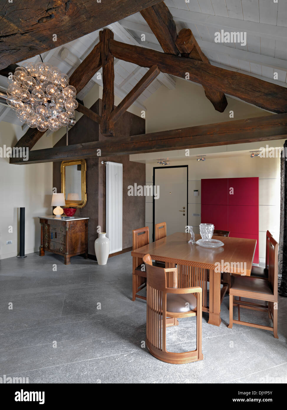 luxurious dining table near to entrance of a attic with trussed roof