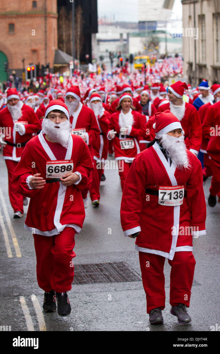 Liverpool, Merseyside, UK  1st December, 2013. Runners at the Liverpool Santa Dash starting at the Pier Head and attempting to break the Guinness World Record for the ‘Largest Santa Gathering’ which stands at a staggering 13,000 and also trying to raise to more than last years total of £5 million.  Festive Fun Run is backing the ITV Text Santa Appeal this year to help raise funds for Age UK, Anthony Nolan, Carers UK, Marie Curie Cancer Care, Together for Short Lives and Whizz-Kidz.  Credit:  Mar Photographics/Alamy Live News Stock Photo