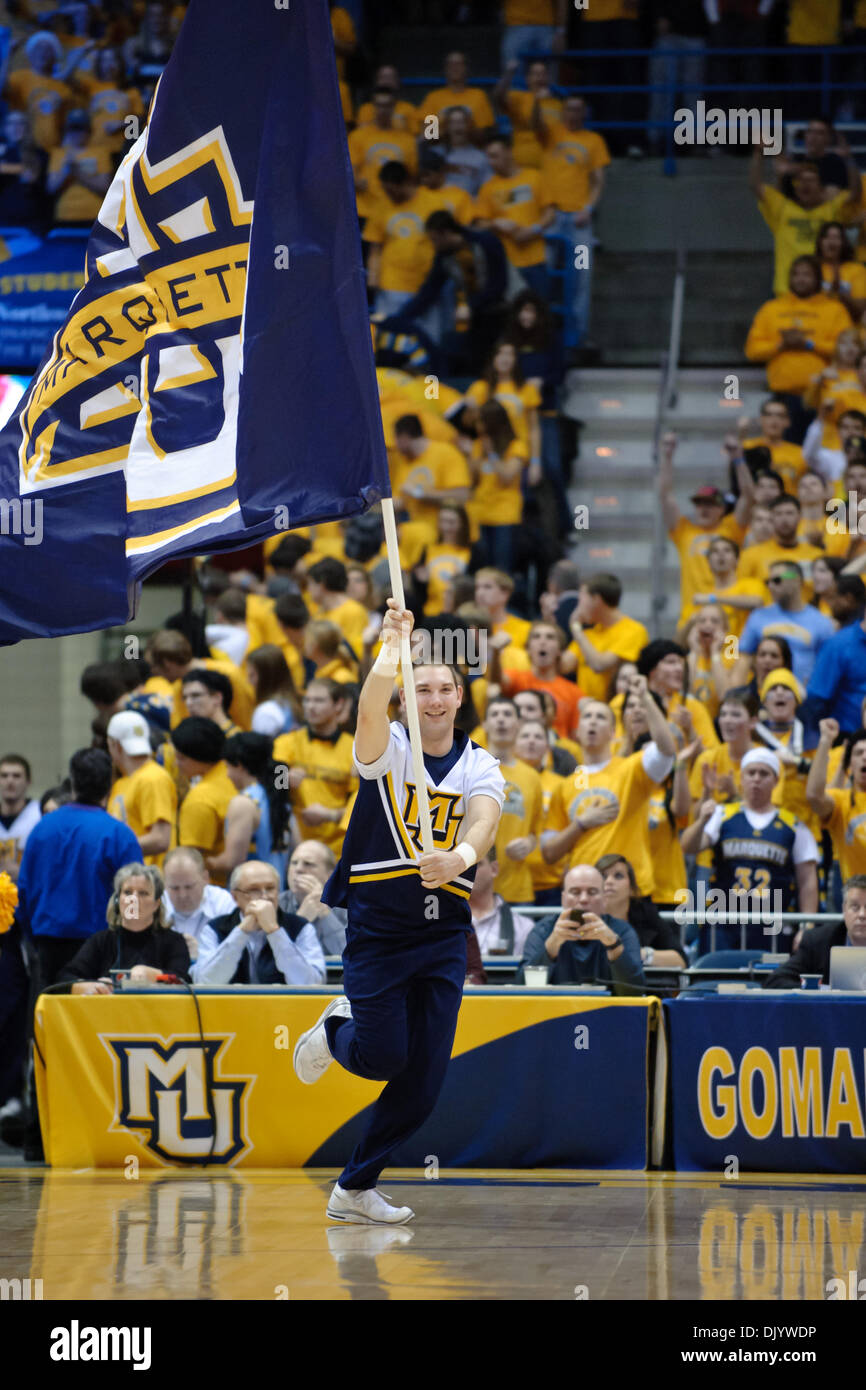 Dec. 11, 2010 - Milwaukee, Wisconsin, United States of America - A Marquette cheerleader carries the MU flag onto the court prior to the game between the Marquette Golden Eagles and the Wisconsin Badgers at the Bradley Center in Milwaukee, WI. Wisconsin defeated Marquette 69-64. (Credit Image: © John Rowland/Southcreek Global/ZUMAPRESS.com) Stock Photo