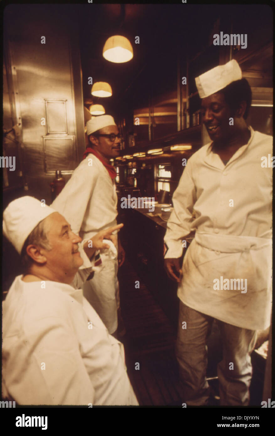 CHEF AND COOKS IN THE GALLEY OF THE LONE STAR TAKE A BRIEF REST FROM THEIR DUTIES OF FEEDING THE