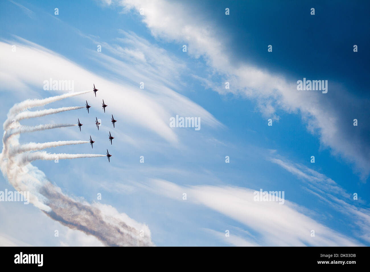 Red Arrows perform a turn with white smoke in their trademark 'Diamond 9' formation, during winter training,Cyprus Stock Photo