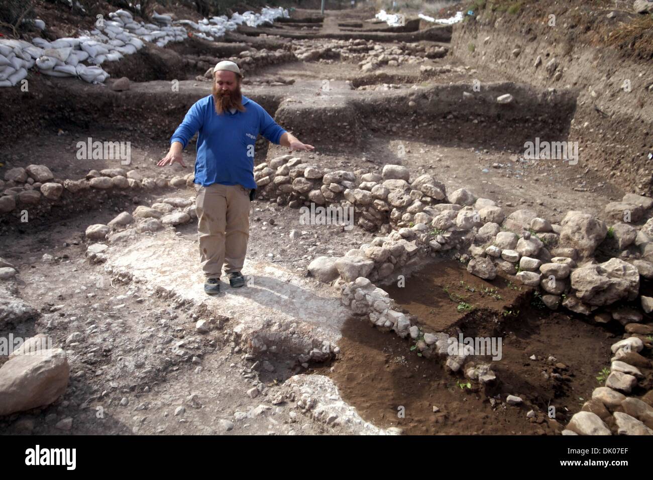 Jerusalem, West Bank, Palestinian Territory. 1st Dec, 2013. An Israeli Israel Antiquities Authority employee inspects a site of excavation revealed at the main access road to Israeli settlement of Beit Shemesh, near Jerusalem on Dec. 01, 2013. An archaeological excavation near Jerusalem has revealed a 10-millennia-old house and a 6,000-year-old cultic temple, discoveries that experts called ''a fascinating glimpse into thousands of years of human development, and evidence of man's transition to permanent dwellings Credit:  Saeed Qaq/APA Images/ZUMAPRESS.com/Alamy Live News Stock Photo