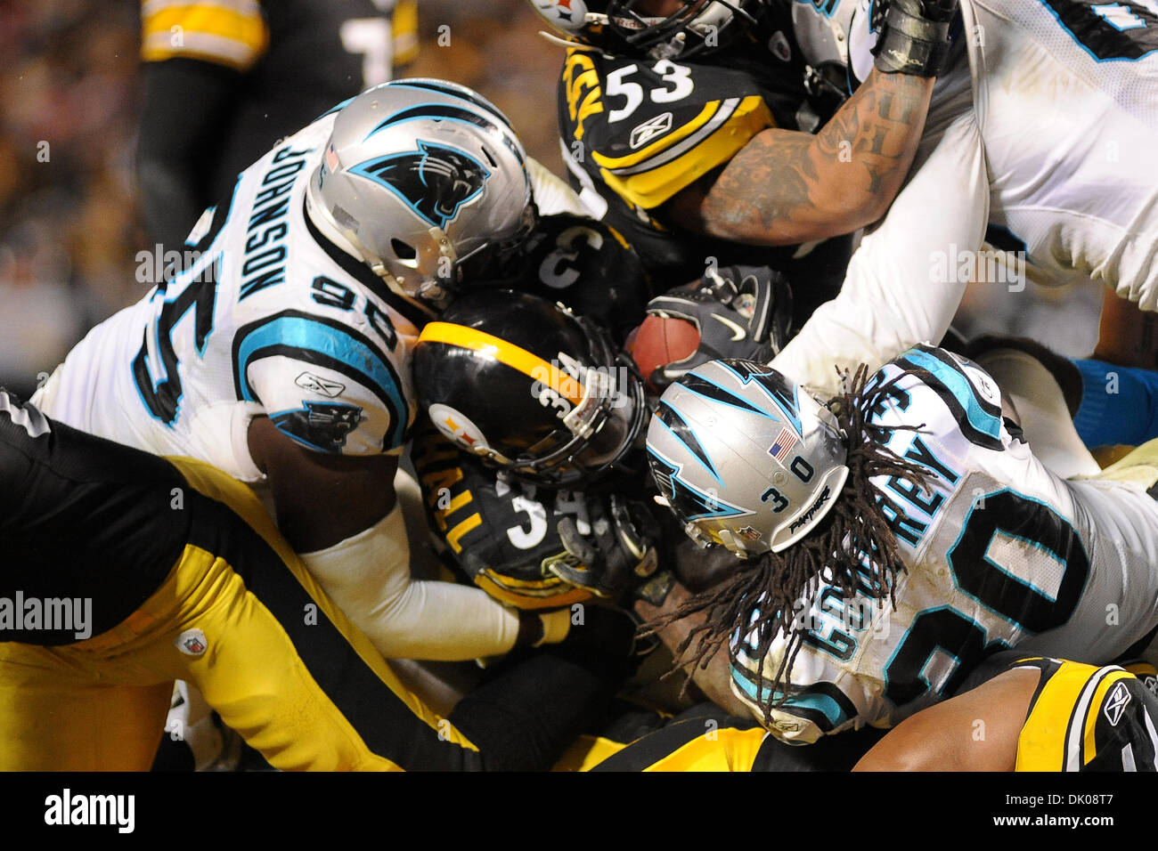 Dec. 23, 2010 - Pittsburgh, PENNSYLVANNIA, U.S - Pittsburgh Steelers running back Rashard Mendenhall (34) tries to get up the middle but is stopped for no gain by Carolina Panthers defensive end Charles Johnson (95) and Carolina Panthers safety Charles Godfrey (30) in the third quarter as the Steelers take on the Panthers at Heinz Field in Pittsburgh, PA...The Steelers defeat the P Stock Photo