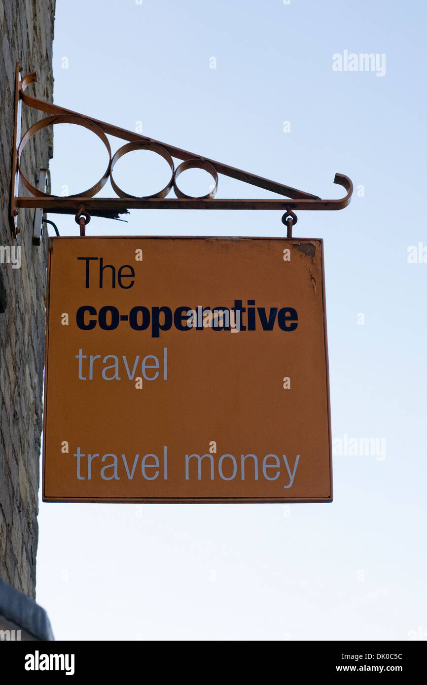 Sign for Co-operative travel shop against a blue sky. Stock Photo