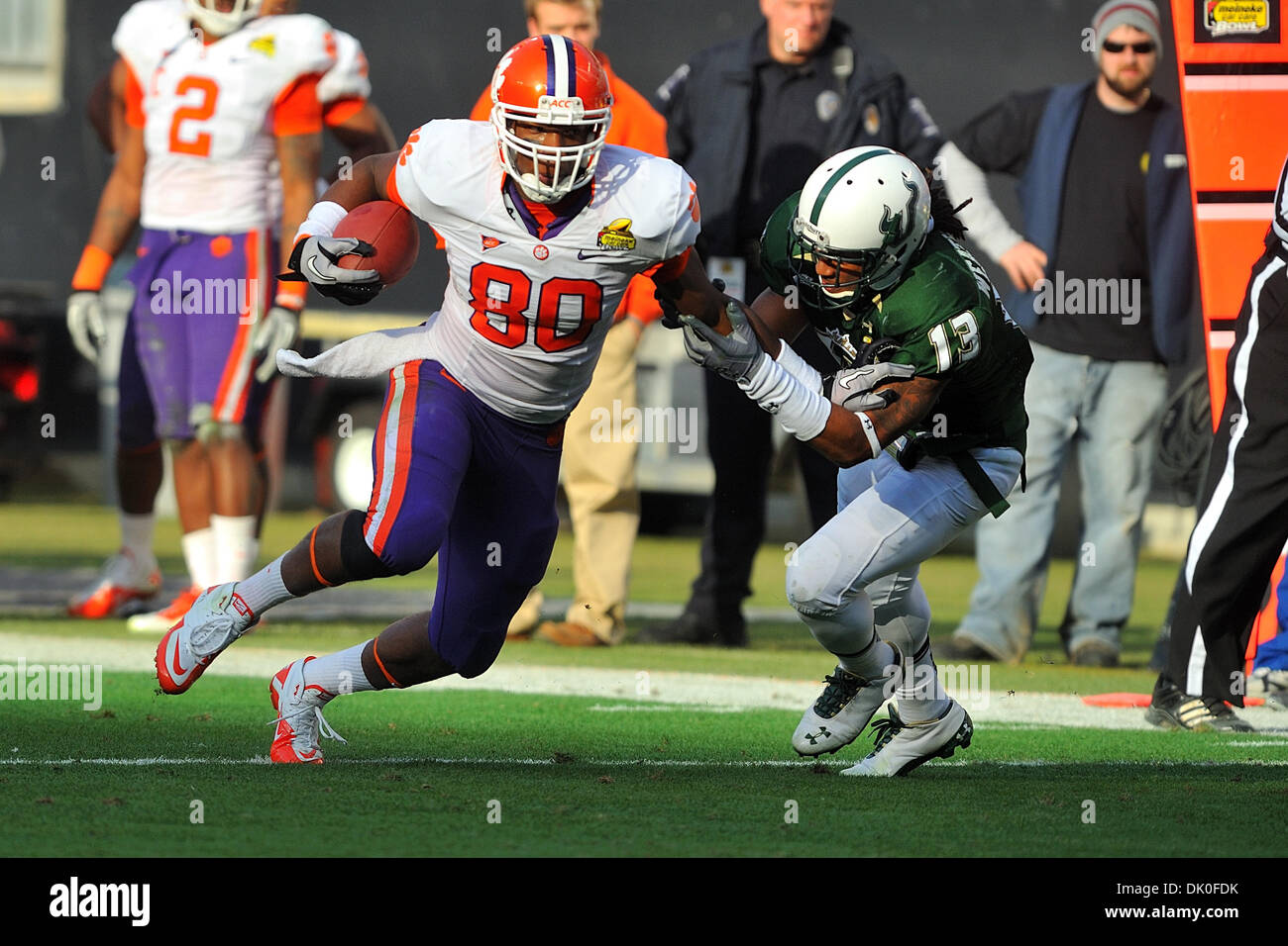 Dec. 31, 2010 - Charlotte, North Carolina, USA - Clemson tight end Brandon Ford (80) tries to break loose from Curtis Weatherspoon (13) of USF during late fourth quarter play.  South Florida defeats Clemson 31-26 in the Meineke Car Care Bowl at Bank of America Stadium in Charlotte, North Carolina. (Credit Image: © Tim Cowie/Southcreek Global/ZUMAPRESS.com) Stock Photo