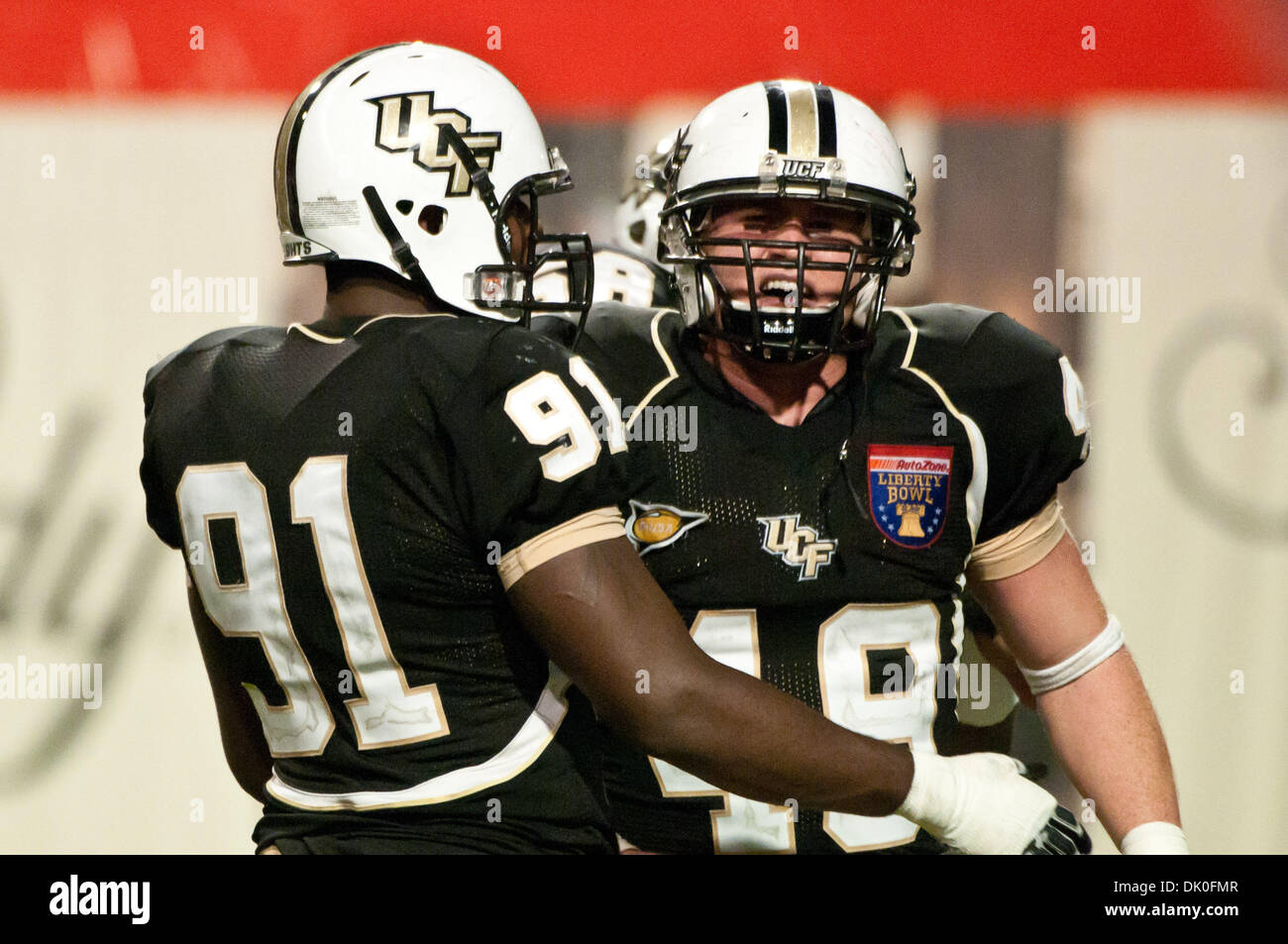 Dec. 31, 2010 - Memphis, Tennessee, United States of America - UCF Knights defensive end Bruce Miller (49) celebrates with UCF Knights defensive lineman Victor Gray (91) after sacking Georgia Bulldogs quarterback during the NCAA Liberty Bowl game between the University of Central Florida and the University of Georgia. Final Score the UCF Knights are defeat the Georgia Bulldogs 10 - Stock Photo