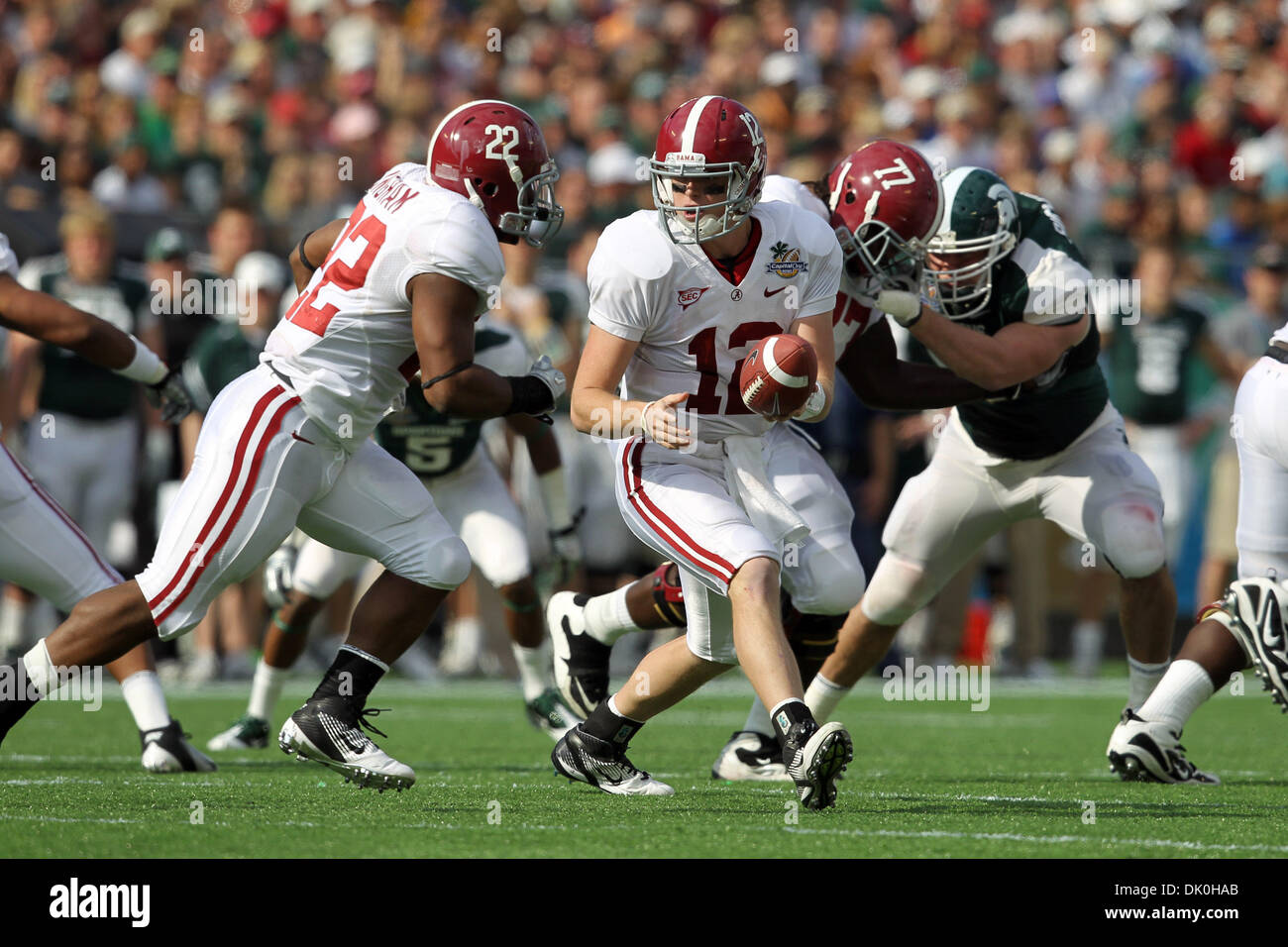 Jan. 1, 2011 - Orlando, Florida, United States of America -  Alabama Crimson Tide QB Greg Mcelroy (12) prepares to hand the ball off to RB Mark Ingram (22) during the 2011 Capital One Bowl held at the Florida Citrus Bowl in Orlando, FL. (Credit Image: © Don Montague/Southcreek Global/ZUMAPRESS.com) Stock Photo