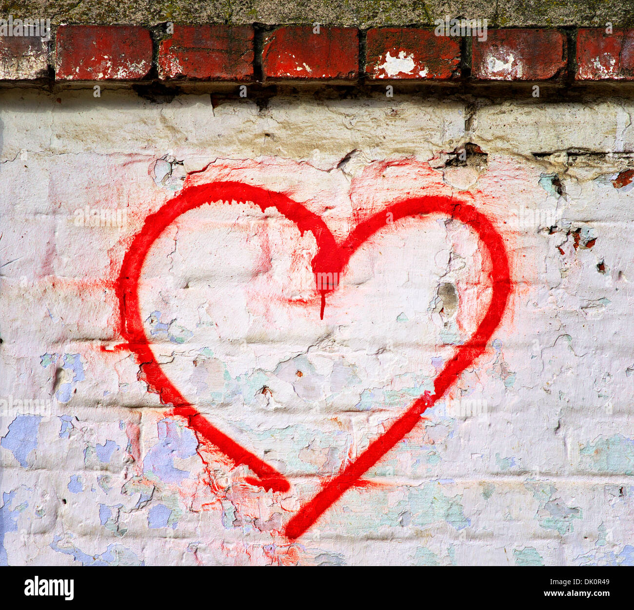 Red Love Heart hand drawn on brick wall grunge textured background trendy street style Stock Photo