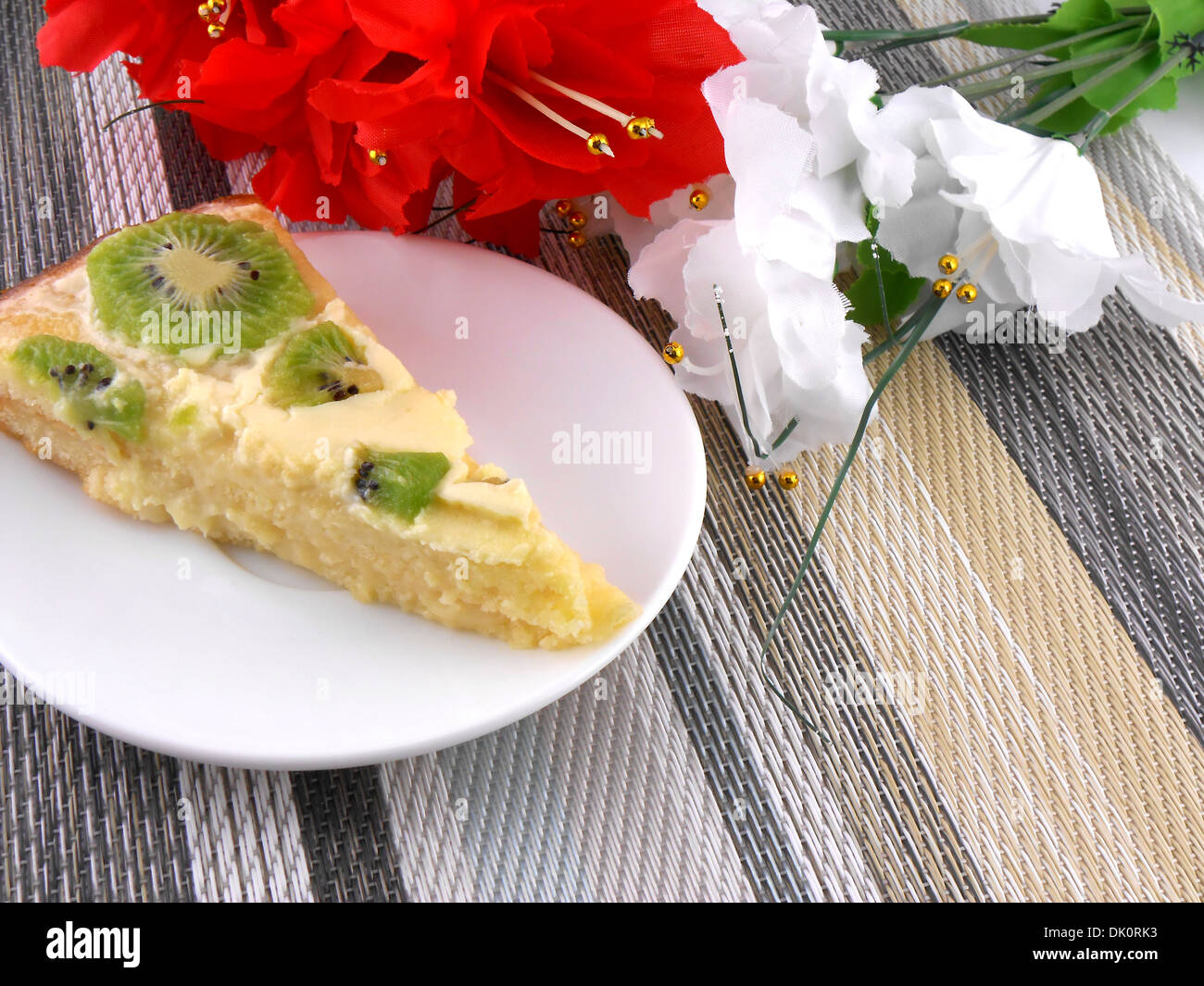 cake with fruits with red and white flowers Stock Photo