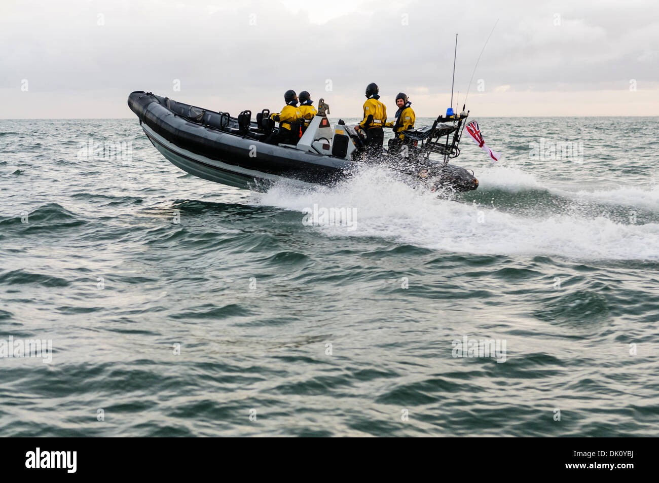 Belfast, Northern Ireland. 30th Nov 2013 - A Royal Navy VT Halmatic Pacific 22 pursuit RIB splashes over waves at speed with four passengers on board wearing dry-suits. Credit:  Stephen Barnes/Alamy Live News Stock Photo