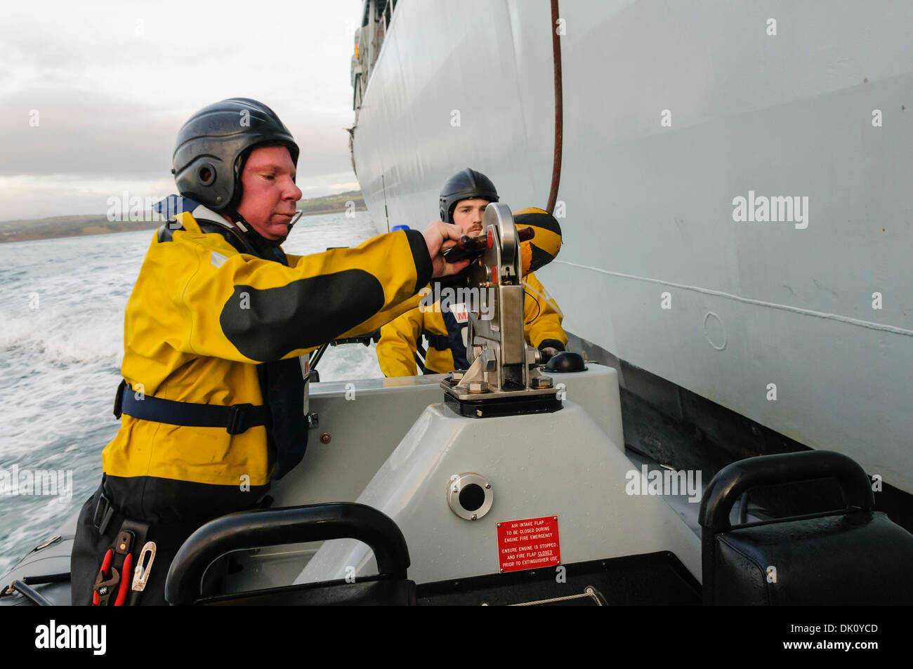 Belfast, Northern Ireland. 30th Nov 2013 - A pursuit RIB from HMS Monmouth pulls up alongside the ship and a winch line is dropped down prior to being winched up. Credit:  Stephen Barnes/Alamy Live News Stock Photo
