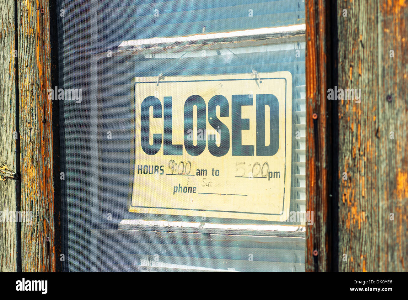Old wooden door with hanging Closed sign Stock Photo