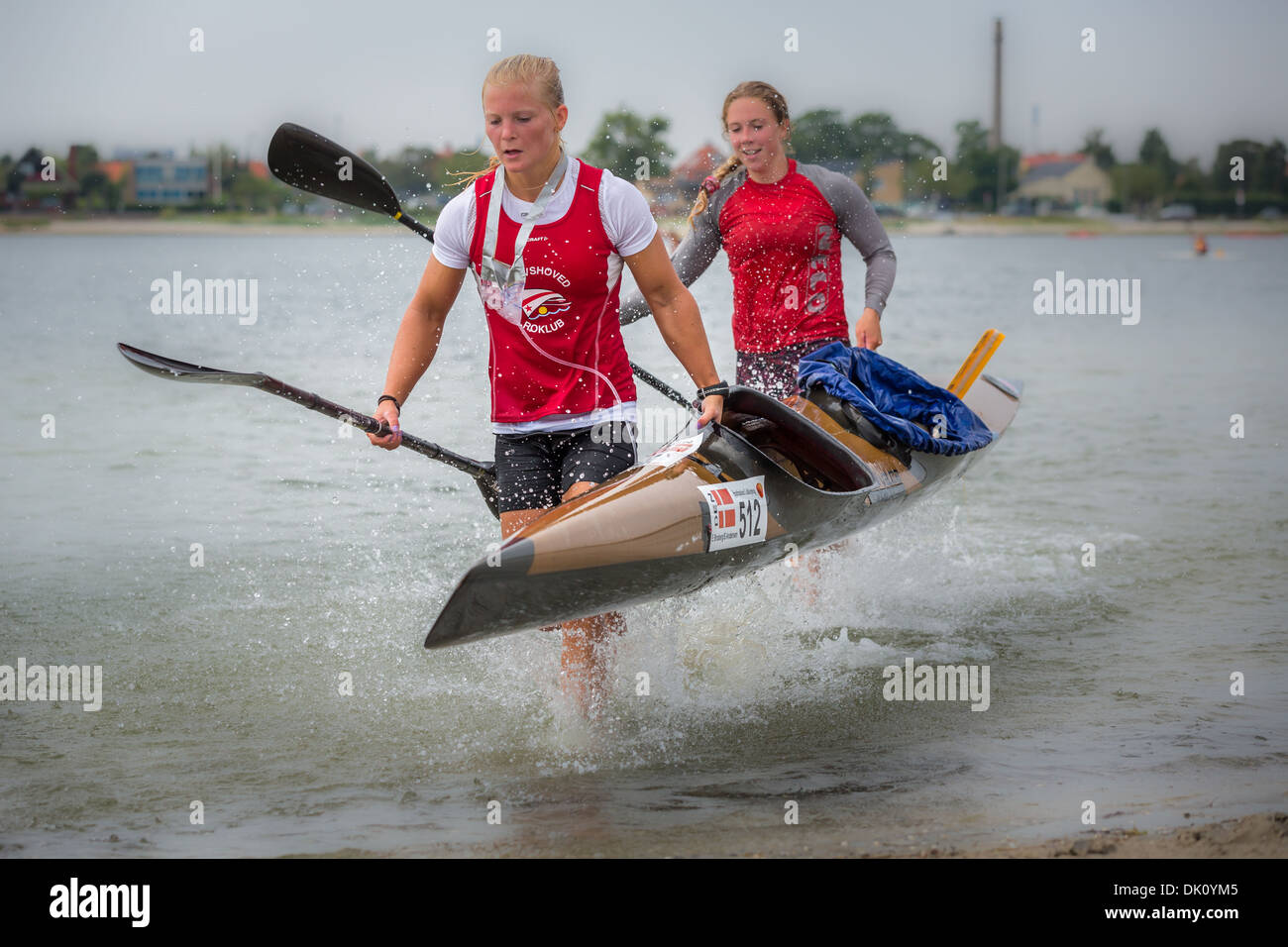 Two female kayakers carrying a kayak, Copenhagen Beach Marathon for Kayak and Canoe, Copenhagen,  Denmark Stock Photo